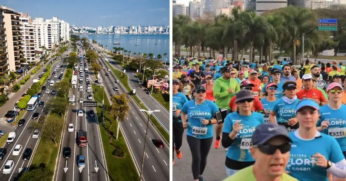 Multidão de corredores em evento, utilizando camisetas azuis, numa avenida com vegetação e prédios ao fundo.
